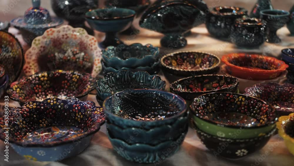 Ceramic tableware close up at the oriental market. Colorful bowls at bazaar. Popular market tourist destination.