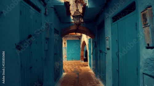 Walking through a narrow street inside old Medina of Chechaouen city, Morocco at Morning.