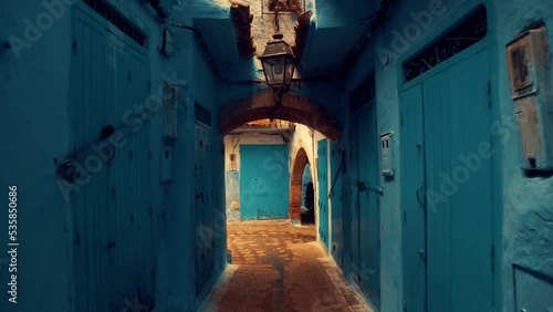 Walking through a narrow street inside old Medina of Chechaouen city, Morocco at Morning. photo