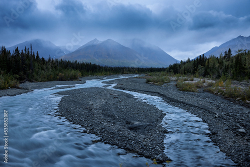 Wild river in the Mountains at bad weather, Kluane National Park, Yukon, Canada photo