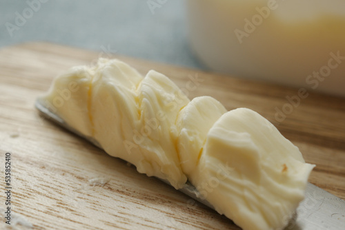 close up of fresh butter in a container 