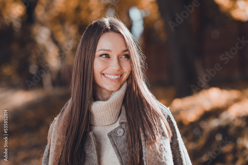 Photo of lovely brown hairdo young lady look wear coat sweater at the street in autumn