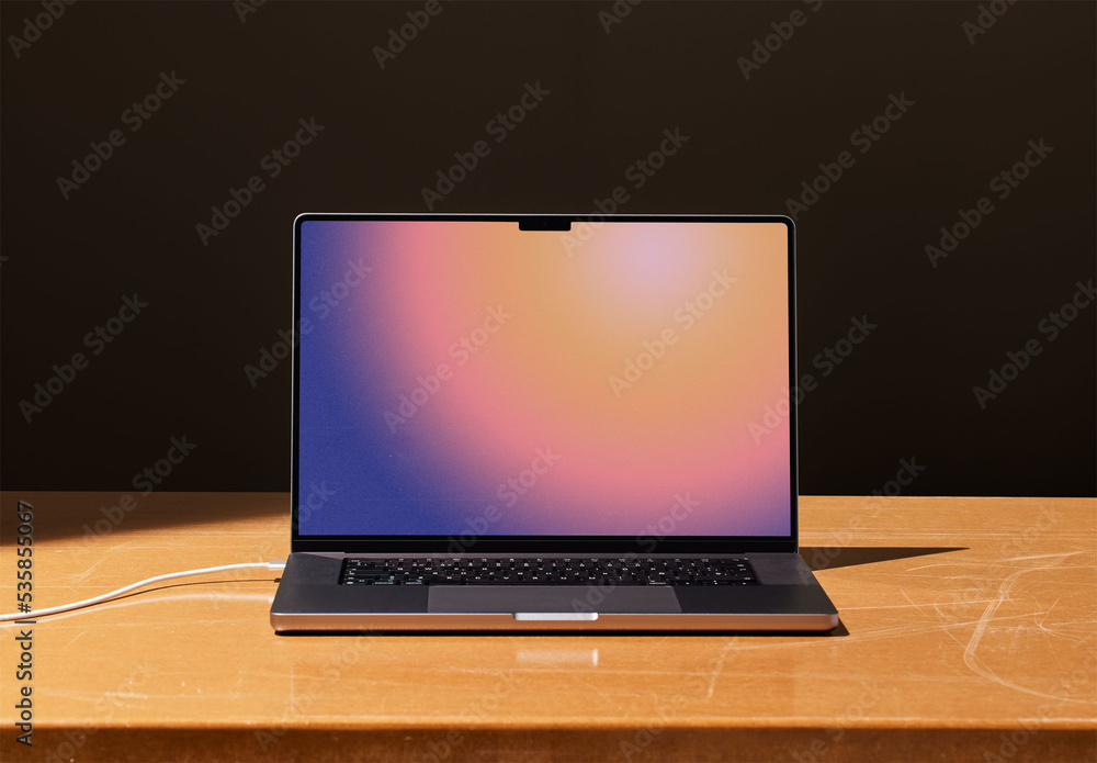 Frontal Laptop Mockup with Dark Background and Brown Table Stock