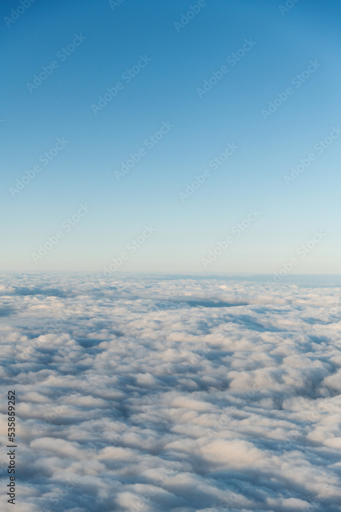 Looking at the cloudscape through airplane window Looking at the cloudscape through airplane window