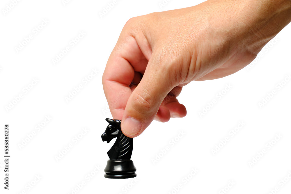 Black chess piece in hand on a white background. Black chess piece in hand on a white background.
