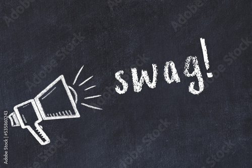 Chalk loudspeaker and inscription swag on black chalkboard