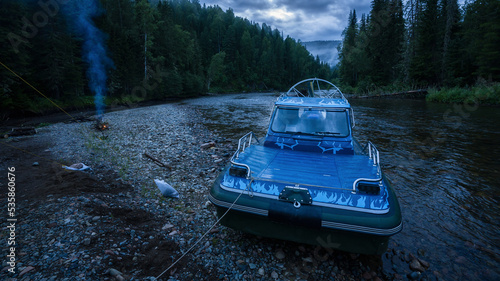 an airboat on a mountain river. Evening boat on the screw.
