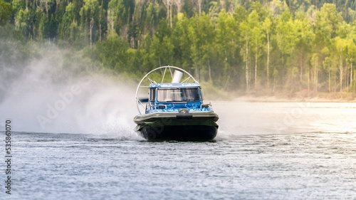 an airboat on the river. The boat on the screw splashes of water.