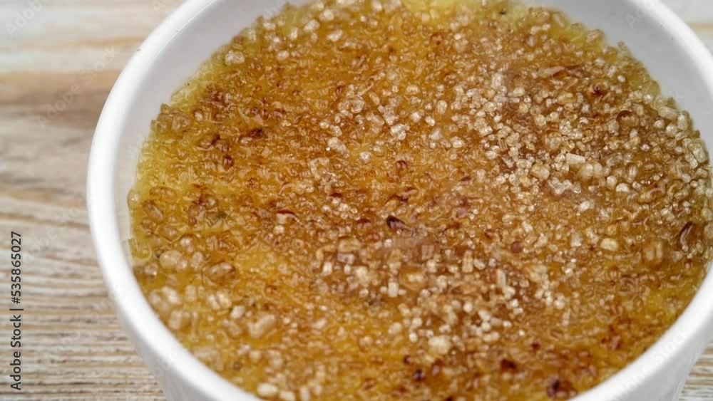 Caramelizing Creme brulee. French dessert.
