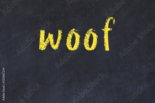 College chalk desk with the word woof written on in
