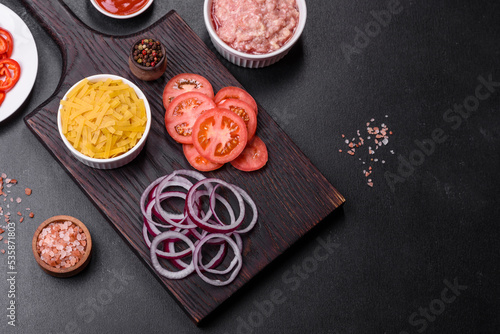 Raw ingredients for delicious Italian pasta: tomatoes, minced meat, pasta, spices and herbs