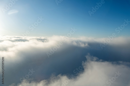 Fluffy white clouds from above © xy