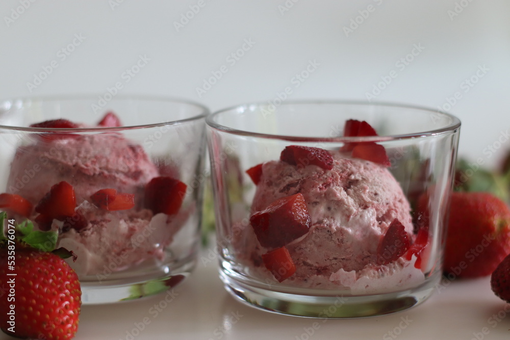 Scoops of Homemade strawberry ice cream. Three ingredient ice cream made of fresh strawberries, whipped cream and condensed milk Scoops of Homemade strawberry ice cream. Three ingredient ice cream made of fresh strawberries, whipped cream and condensed milk