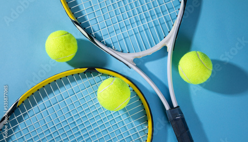 Tennis ball and rackets on the blue background. © andranik123