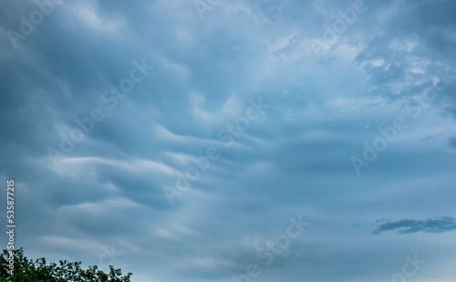 Very dense blue clouds resembling snow or sand dunes