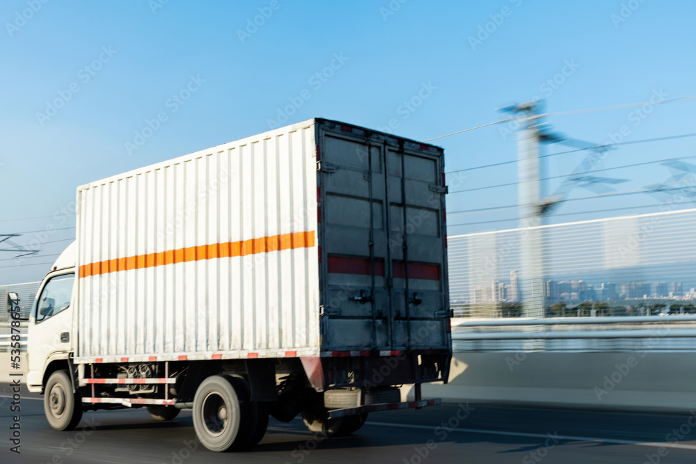 White truck driving on road White truck driving on road