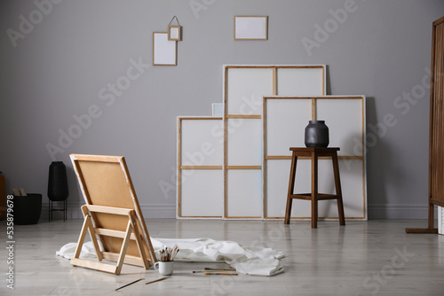 Stylish artist's studio interior with canvas and brushes