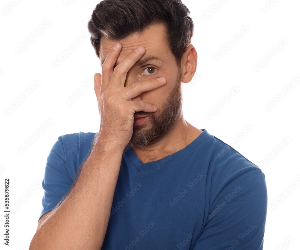 Embarrassed man covering face with hand on white background Embarrassed man covering face with hand on white background
