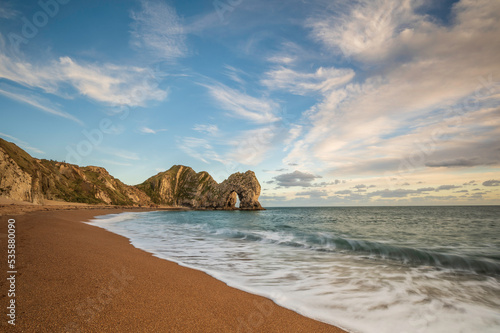 Durdle Door. Famous coastal geological feature on England's Jurassic Coast, in Dorset.  It is a sunny day.