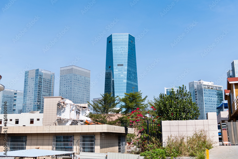 Contrast of demolished old house and modern skyscraper