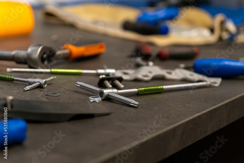 Variety of bikeshop tools on the table, close-up photo