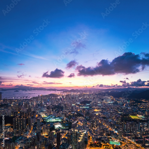 Futuristic cyberpunk view of the famous metropolis, night aerial view of Kowloong Hong Kong.