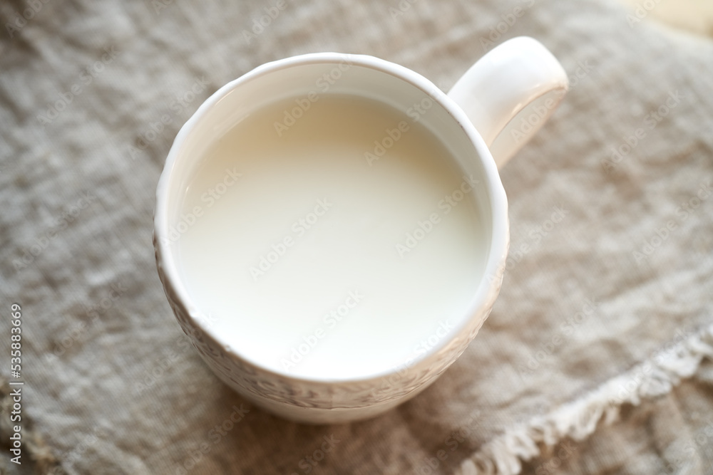 Fresh probiotic kefir in a white cup, top view Fresh probiotic kefir in a white cup, top view