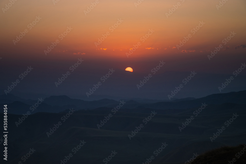 orange-red sunset in the mountains, dusk. beautiful background