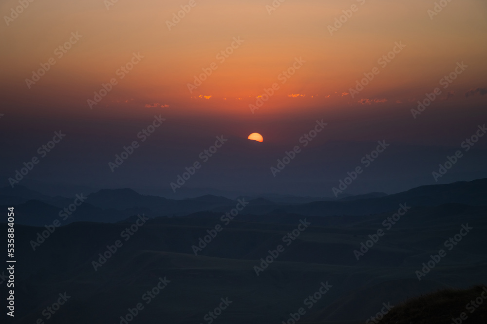 Obraz premium orange-red sunset in the mountains, dusk. beautiful background