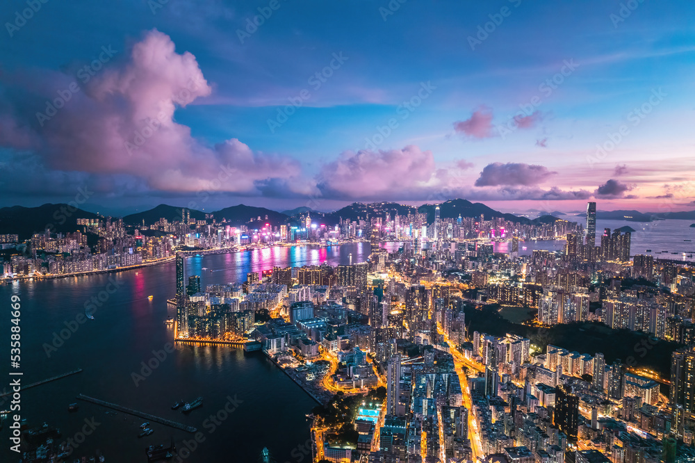 Futuristic cyberpunk view of the famous metropolis, night aerial view of Kowloong Hong Kong.