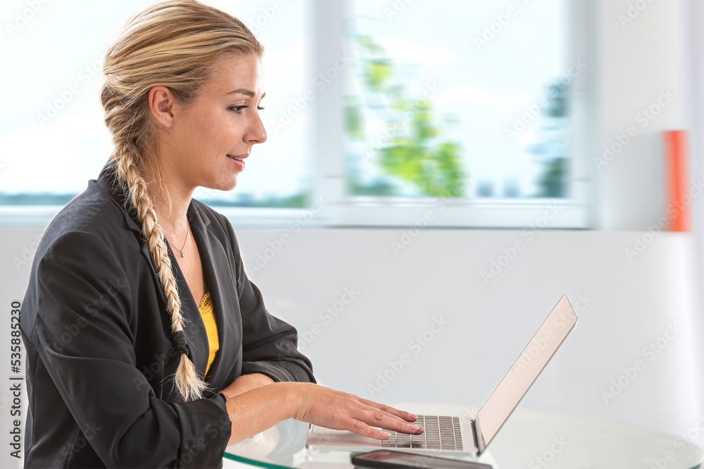Woman in business in front of her computer Woman in business in front of her computer