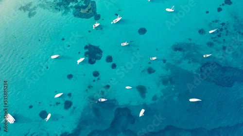 Aerial shot of a tropical island with anchored boats