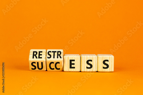 Restress for success symbol. Concept words Restress and Success on wooden cubes. Beautiful orange table orange background. Business restress for success concept. Copy space.