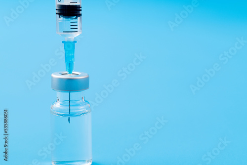 Syringe insertion ampoule on blue background