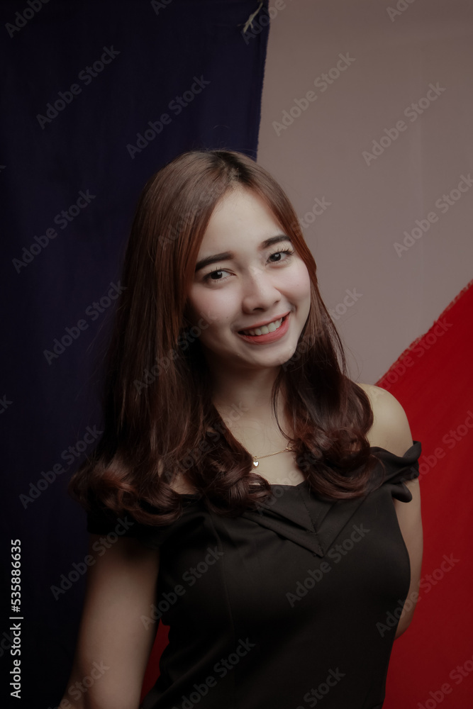 Young Asian women wear dresses or dark clothes. Take pictures and express themselves inside the indoor studio. Young Asian women wear dresses or dark clothes. Take pictures and express themselves inside the indoor studio.