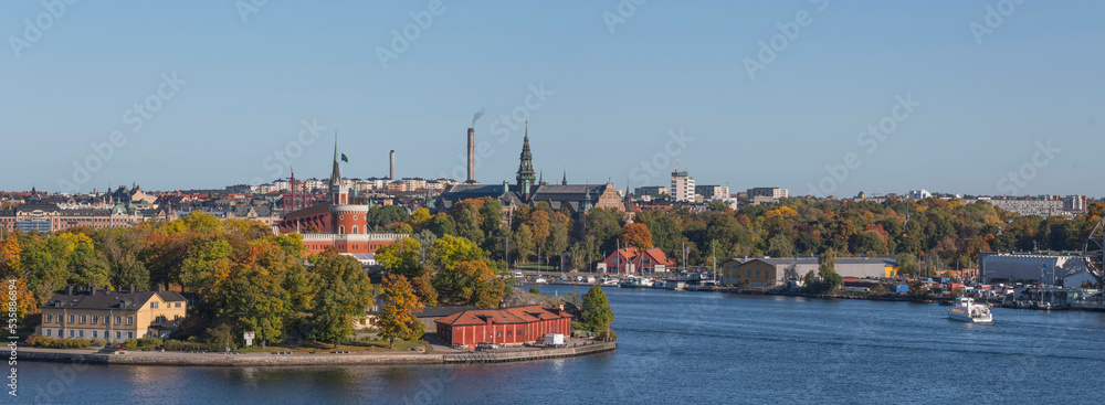Panorama view over the bay Vasadjupet with a symbolic brick castell, the museum boat park and the district Djurgården and Östermalm a colorful sunny autumn day in Stockholm