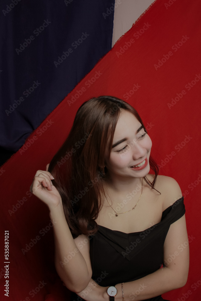 Young Asian women wear dresses or dark clothes. Take pictures and express themselves inside the indoor studio. Young Asian women wear dresses or dark clothes. Take pictures and express themselves inside the indoor studio.
