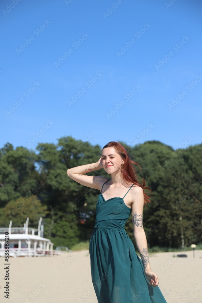beautiful girl in a dress on the beach