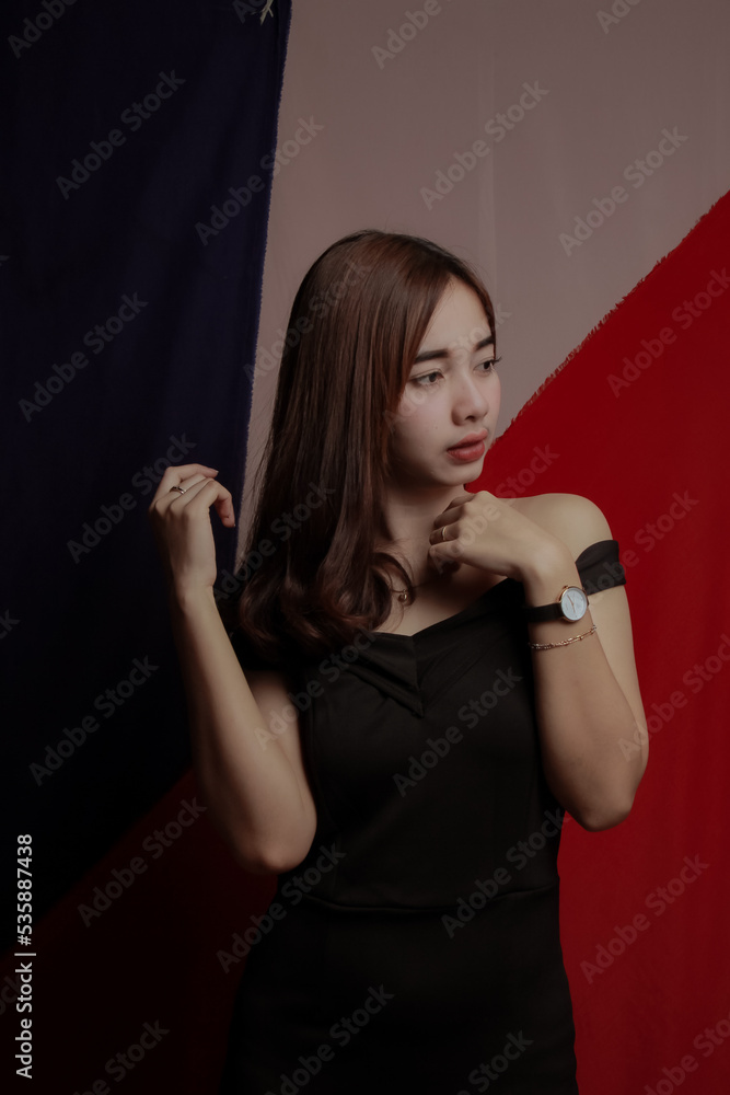 Young Asian women wear dresses or dark clothes. Take pictures and express themselves inside the indoor studio. Young Asian women wear dresses or dark clothes. Take pictures and express themselves inside the indoor studio.