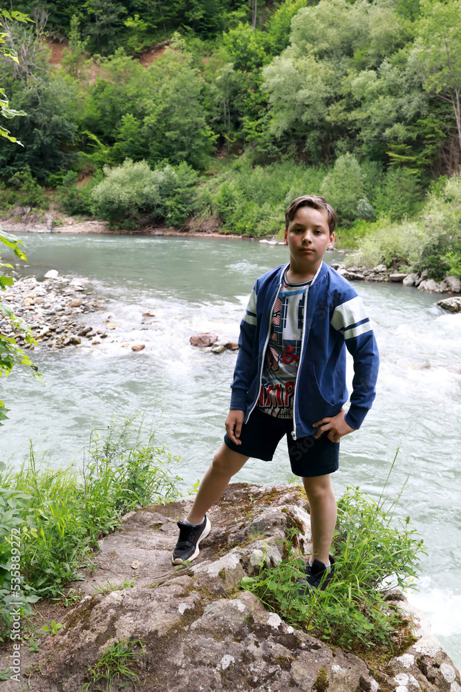 Child on bank of Belaya river in granite gorge Child on bank of Belaya river in granite gorge