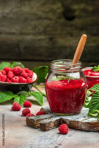 homemade raspberry jam or confiture on light background. vertical image. top view. place for text