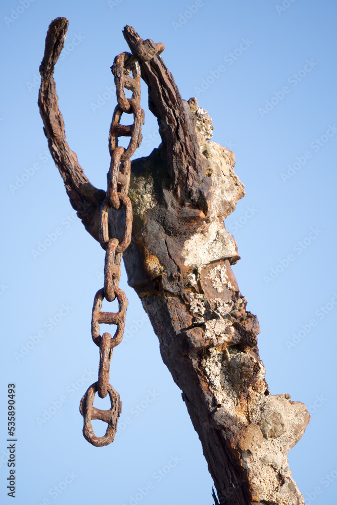 Rusty ship chain close at Nieva lighthouse in Gozon Asturias Spain Rusty ship chain close at Nieva lighthouse in Gozon Asturias Spain