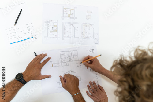 Two young architects working in their studio on a project