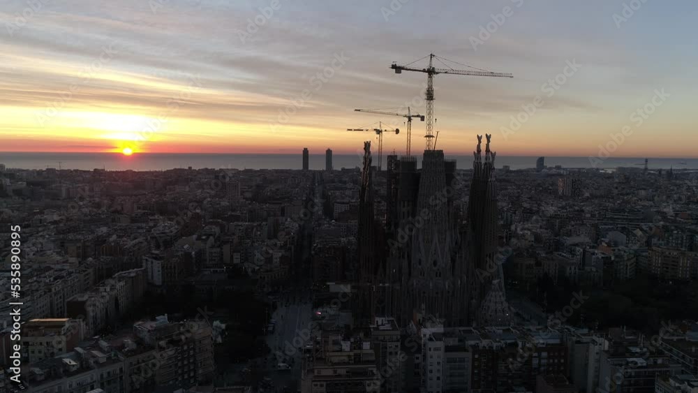 Aerial view of Barcelona city skyline and Sagrada Familia Cathedral at Sunset. Eixample residential famous urban grid. Cityscape with typical urban octagon blocks. Catalonia, Spain 4k Aerial View Aerial view of Barcelona city skyline and Sagrada Familia Cathedral at Sunset. Eixample residential famous urban grid. Cityscape with typical urban octagon blocks. Catalonia, Spain 4k Aerial View