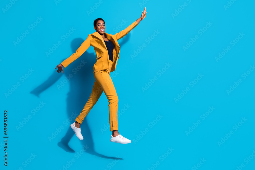 Full body profile side photo of young excited girl guy have fun jump energetic walk isolated over blue color background