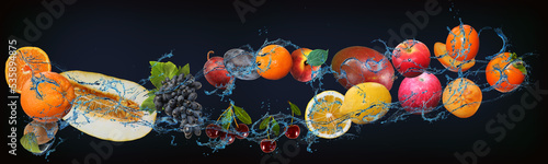 Fototapeta Naklejka Na Ścianę i Meble -  Panorama with fresh fruits in the water - melon, kiwi, lemon, lime, cherry, pear, plum, orange, peach, grapes delicious dessert for New Year, Christmas and Halloween