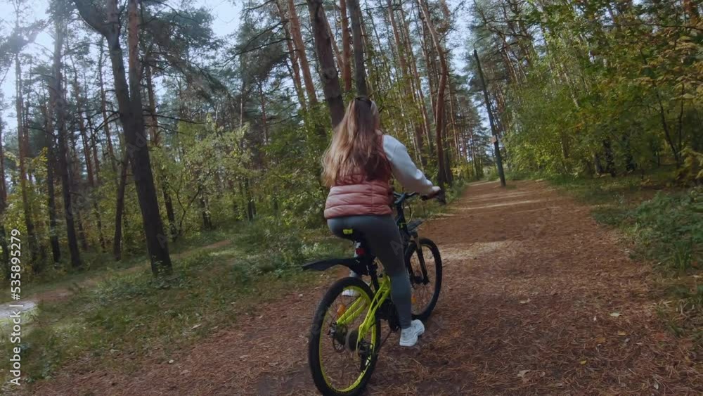 Girl riding bike in autumn forest, fpv shooting, autumn forest, fpv cyclist shooting, green bike Girl riding bike in autumn forest, fpv shooting, autumn forest, fpv cyclist shooting, green bike