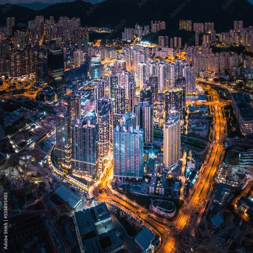 Naklejka premium Futuristic cityscape, cyberpunk tone of metropolis, Kowloon, Hong Kong, Night aerial view