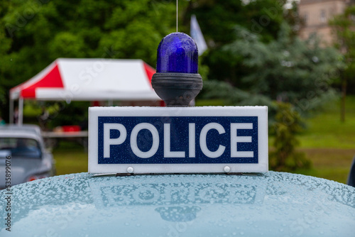 Police sign on top of 1960's car