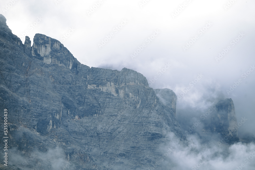 Amazing misty morning on the stunning Dolomite mountains in Italy. Pine forest with clouds and mist Amazing misty morning on the stunning Dolomite mountains in Italy. Pine forest with clouds and mist
